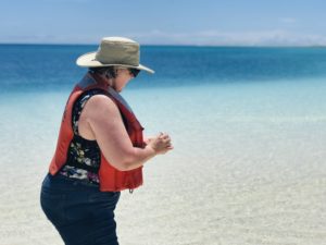 Debbie Fox releases flowers to the ocean in honor of fallen veterans.